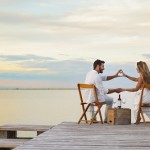 Couple heart shaping with hands at the seaside